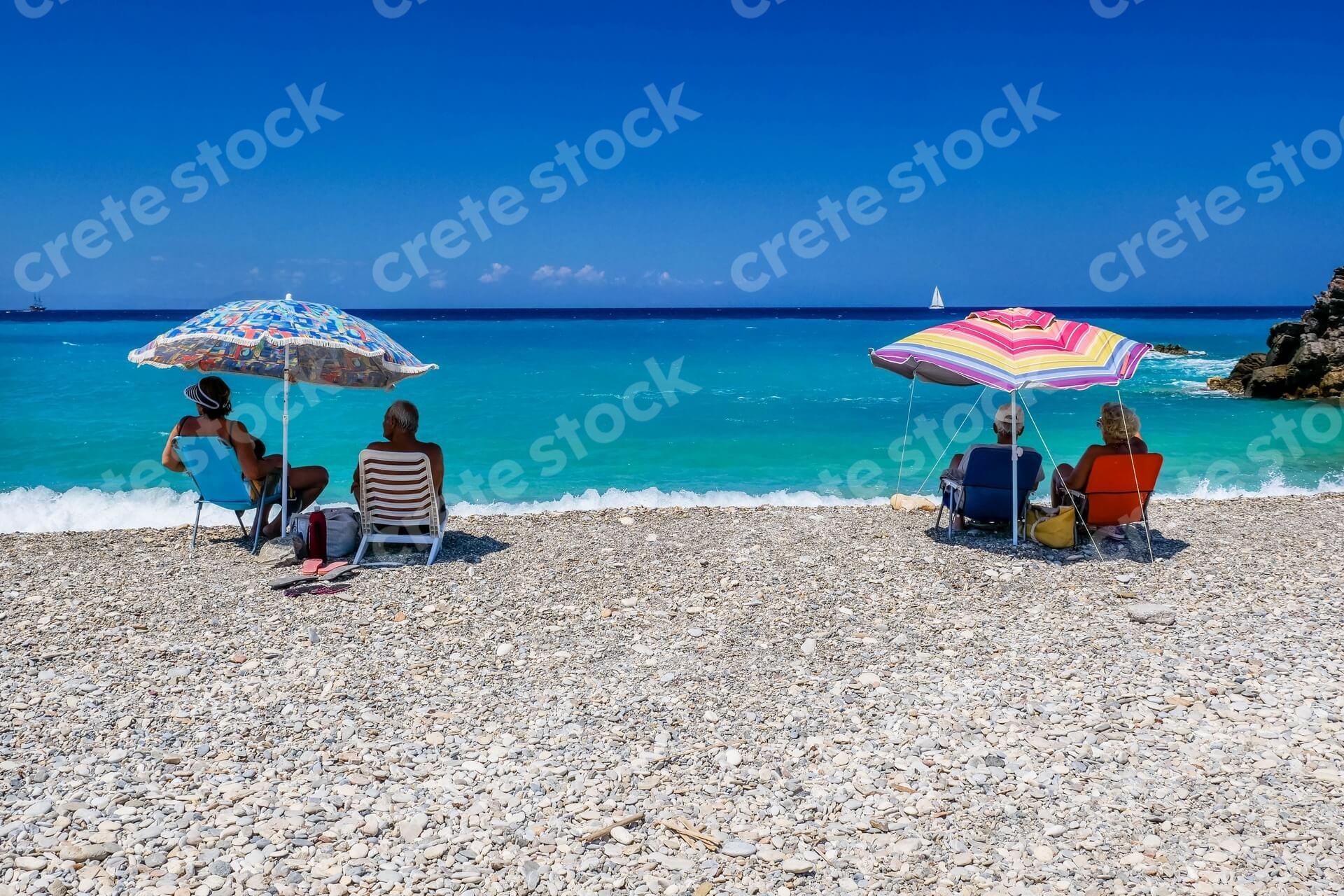 couple-sitting-in-geropotamos-beach-in-rethymno