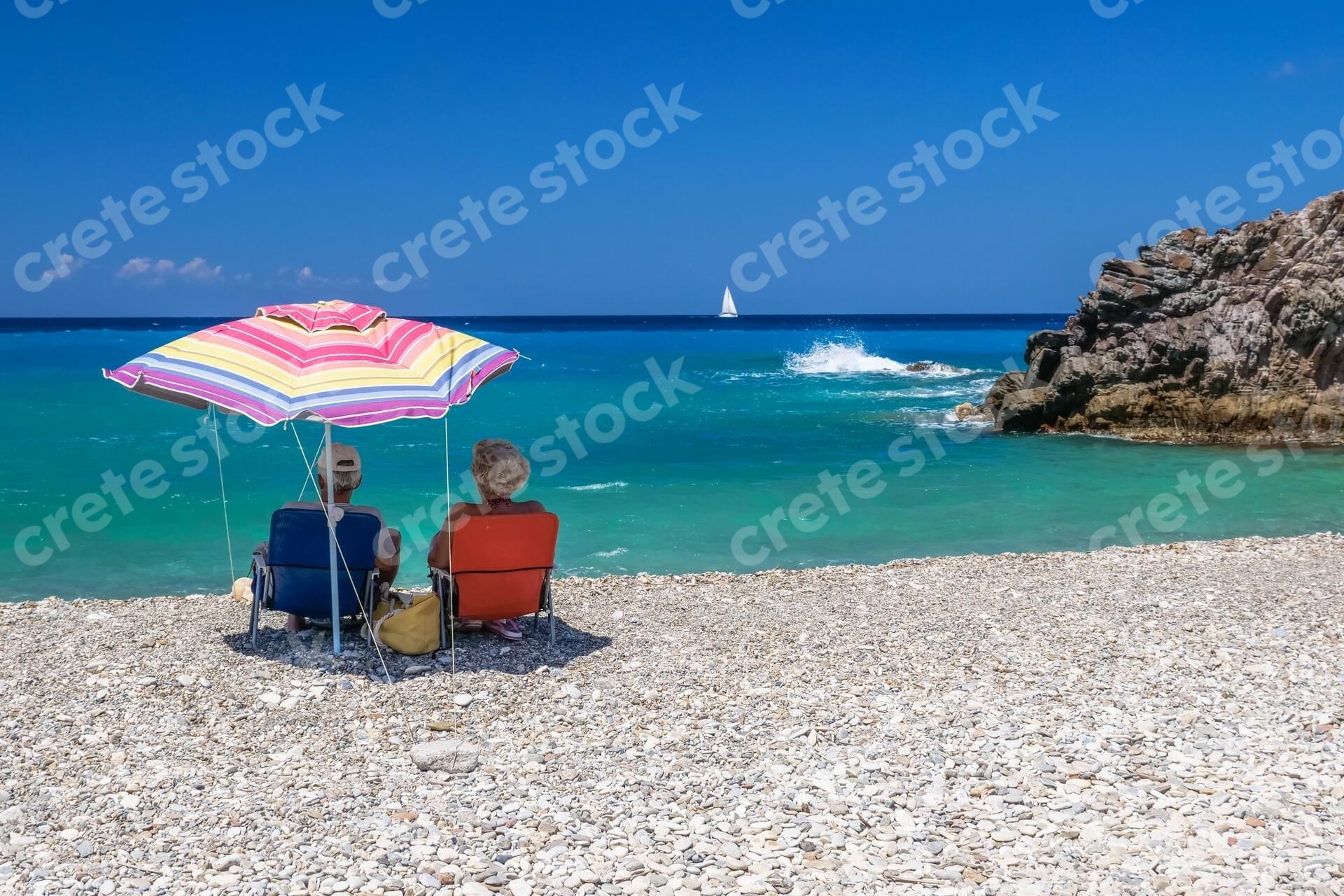 couple-sitting-in-geropotamos-beach-in-rethymno