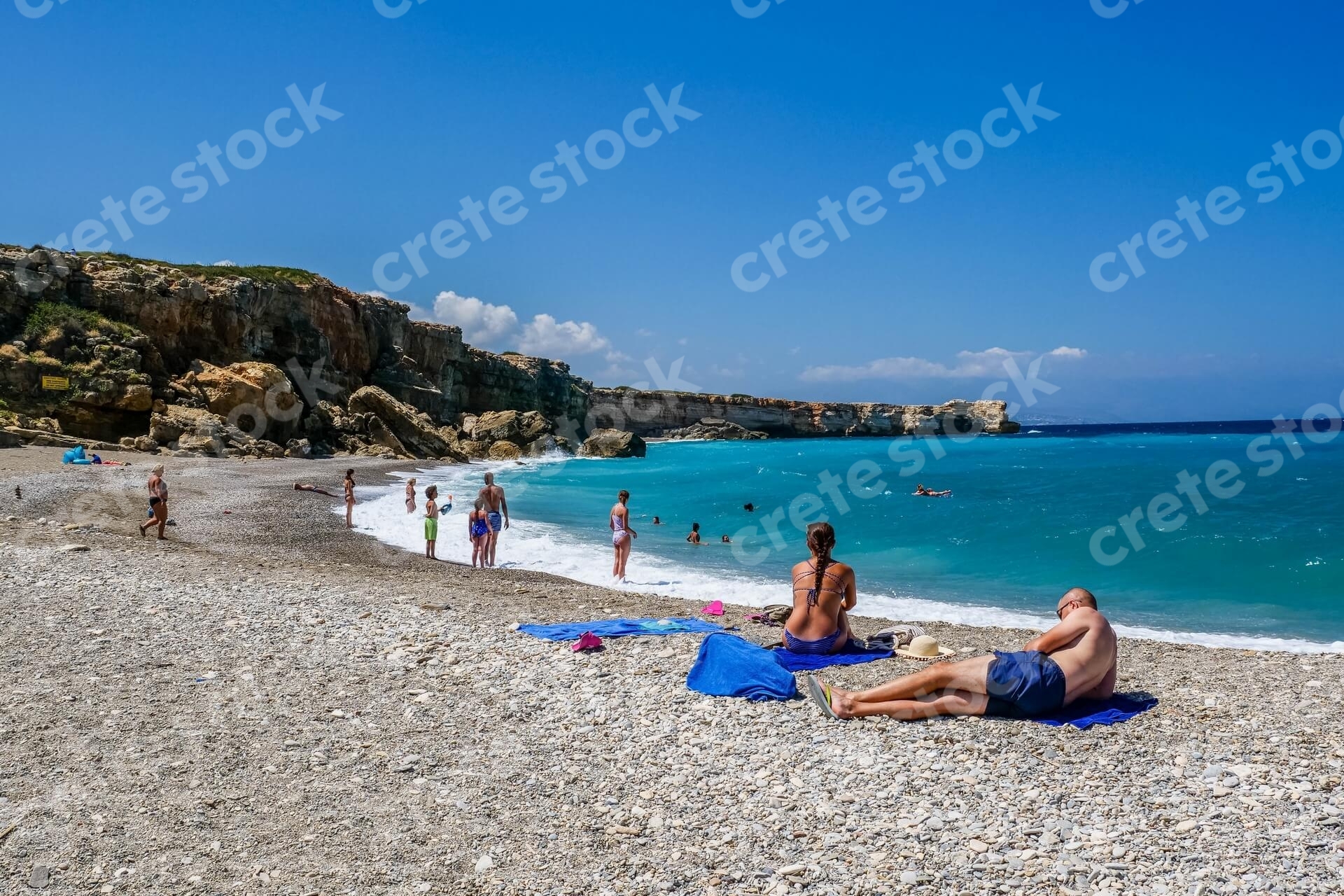 couple-sitting-in-geropotamos-beach-in-rethymno