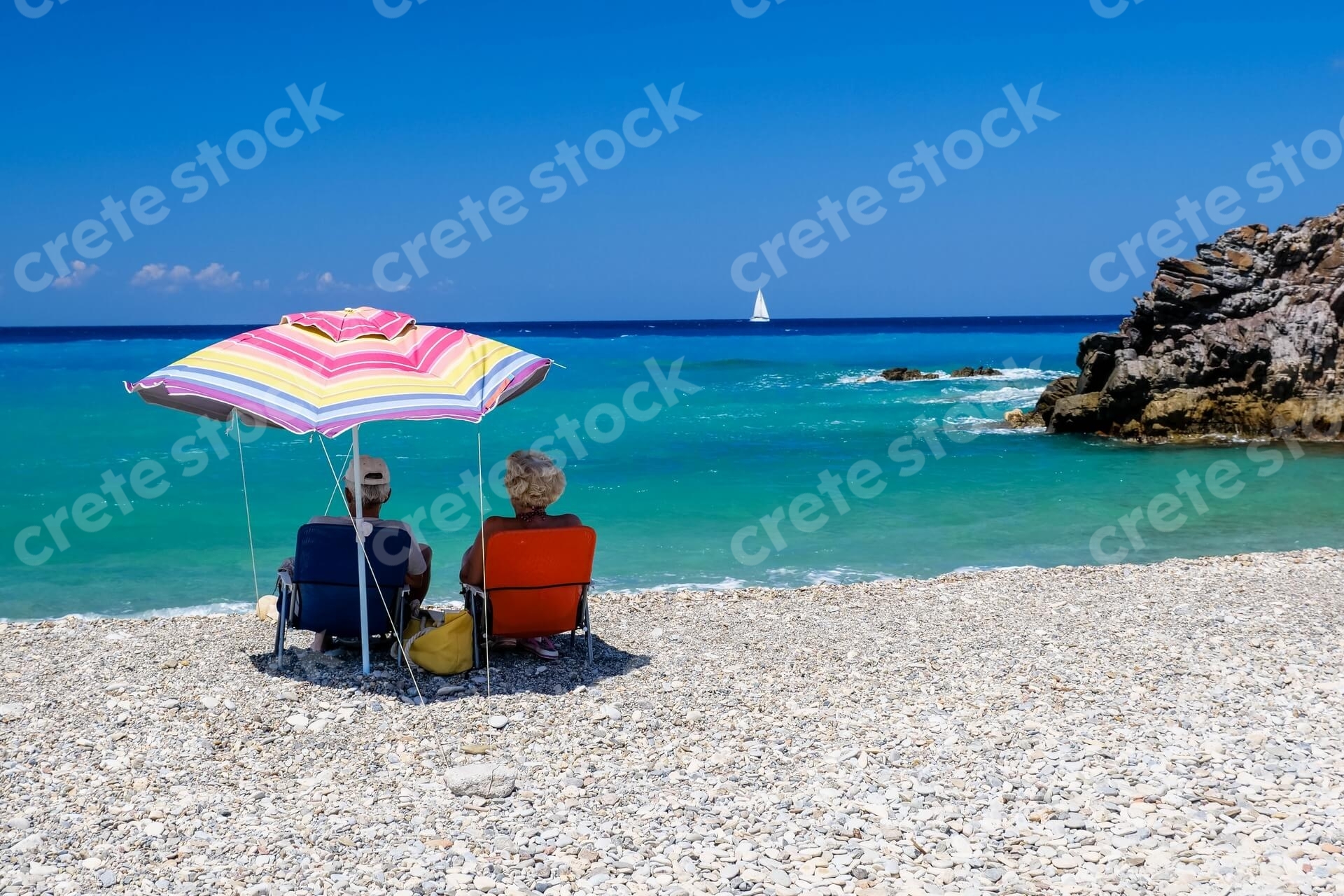 couple-sitting-in-geropotamos-beach-in-rethymno