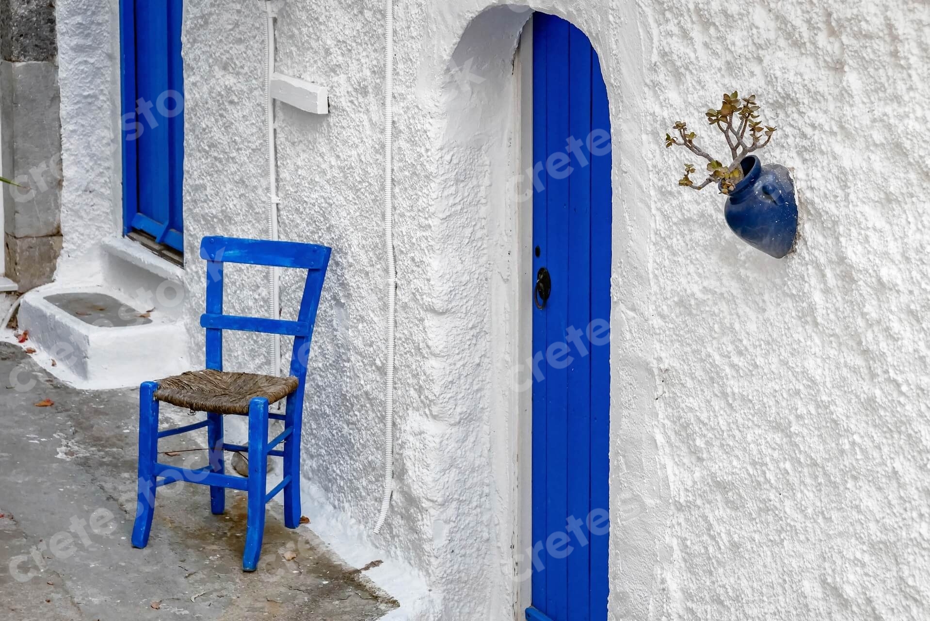 blue-door-chair-in-kritsa-village-in-agios-nikolaos-lasithi